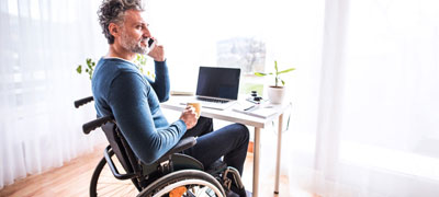 Man in wheelchair talking on the phone